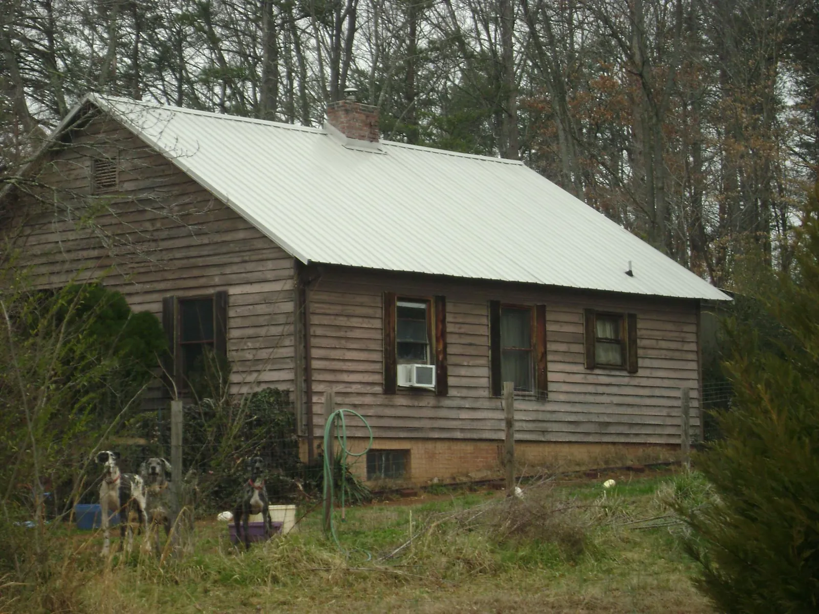 White metal roof on an old wood sided farmhouse, from a Metal Roof Installation job in Germanton